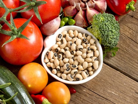 Black eyed peas in a bowl and vegetables