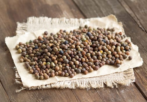 Raw organic roveja beans on a wooden table