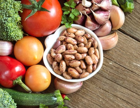 Pinto beans in a bowl and vegetables