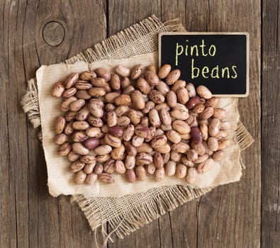 Pinto beans with small chalkboard on a wooden table