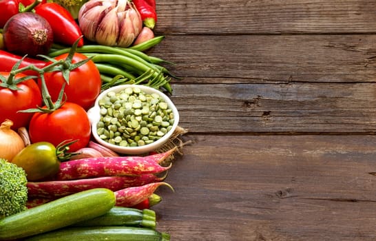 Raw Organic green peas in bowl and vegetables