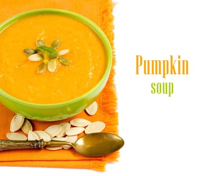 Fresh pumpkin soup in a green bowl with a spoon