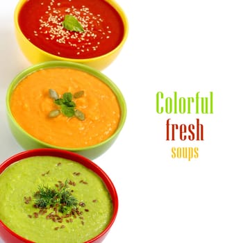 Three fresh soups - tomatoe, pumpkin and green peas soups.
