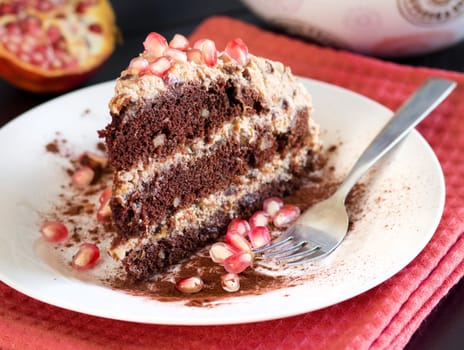 Chocolate, walnut and Prune Cake decorated with pomegranate seeds