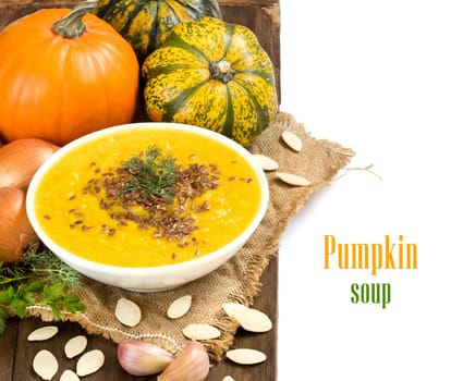 Fresh pumpkin soup with vegetables isolated on white