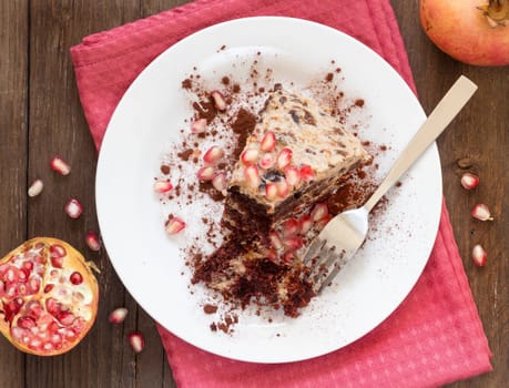 Chocolate, walnut and Prune Cake decorated with pomegranate seeds