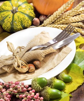 Rustic autumn table setting on wooden table