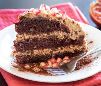 Chocolate, walnut and Prune Cake decorated with pomegranate seeds