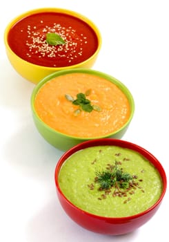 Three fresh soups - tomatoe, pumpkin and green peas soups