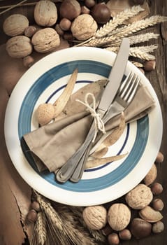Autumn table setting with nuts and wheat
