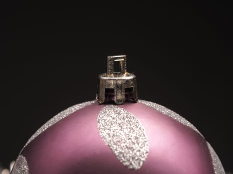 Closeup of a Christmas bauble on a dark background with space for text