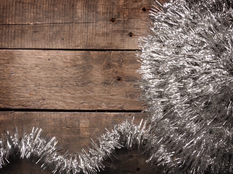 Christmas background with silver decoration on a rustic wooden table