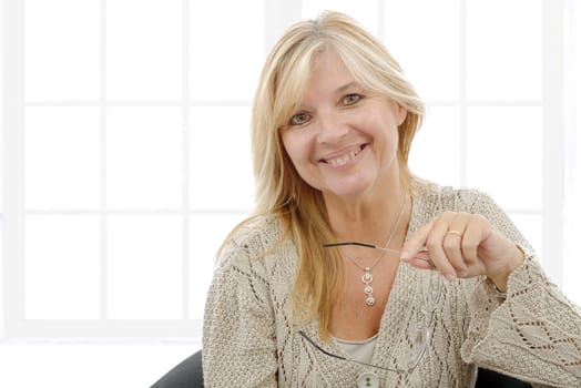 a portrait of mature smiling blond woman