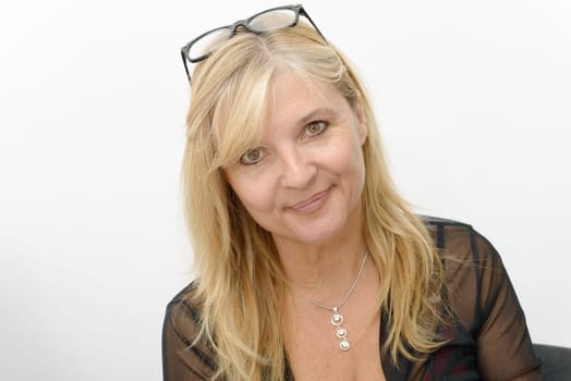 a portrait of mature smiling blond woman