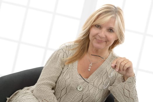 a portrait of mature smiling blond woman