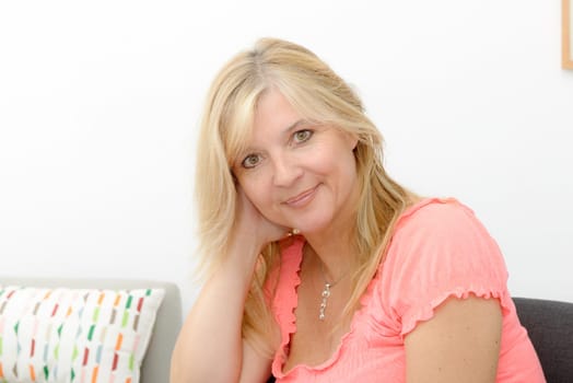 a portrait of mature smiling blond woman