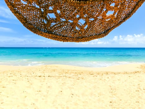 The blue color of sea, hat and white sand at Caribbean shore