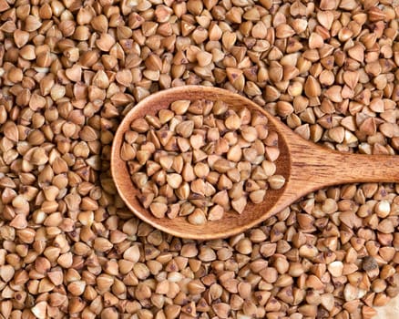 Buckwheat and a spoon close up background