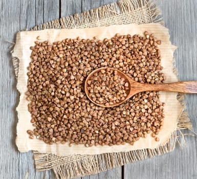 Buckwheat on a wooden table with a spoon
