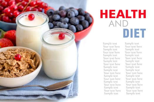 Jars of fresh natural yogurt, berries and cereals in bowls