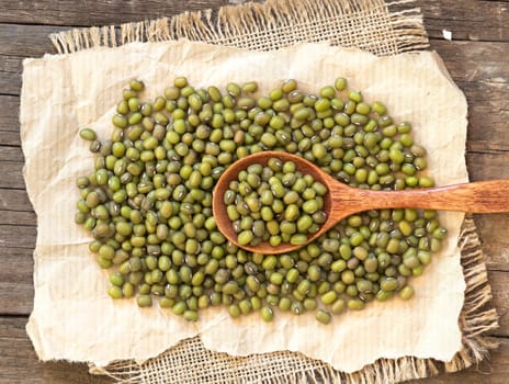 Mung beans and spoon on a wooden table