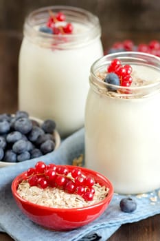 Jars of fresh natural yogurt, berries and cereals