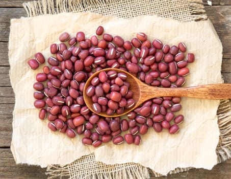 Azuki beans and spoon on a wooden table