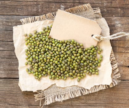 Mung beans and paper label on a wooden table