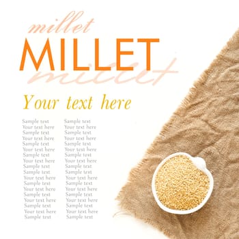 Raw millet in a bowl on burlap