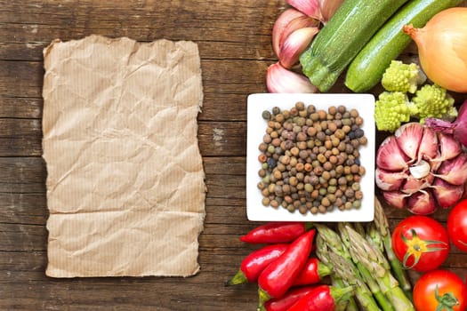 Raw organic roveja beans and vegetables on wooden table