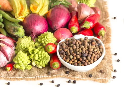 Raw organic roveja beans and vegetables isolated on white