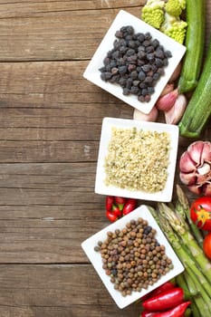 Roveja, hemp seeds, black chickpea and vegetables on a wooden table