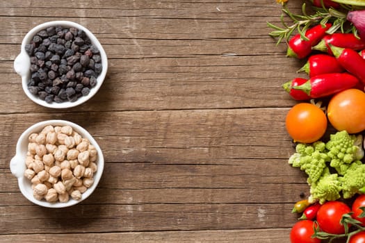 Vegetables and chickpea on a wooden table background