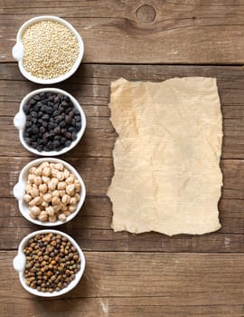 Cereals and legumes in bowls on a wooden table