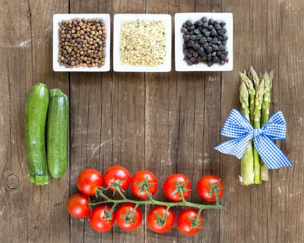 Roveja, hemp seeds, black chickpea and vegetables on a wooden table