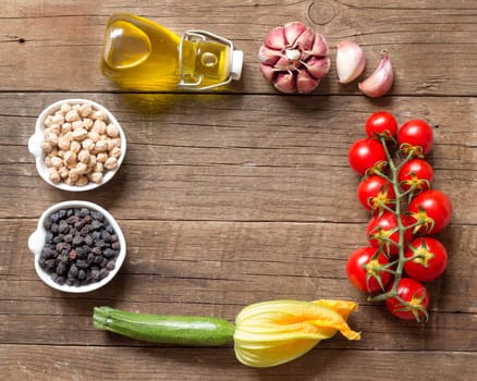 Vegetables and chickpea on a wooden table background