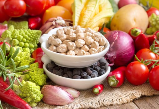 Black and white chickpea in bowls with vegetables