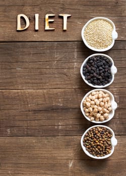 Cereals and legumes in bowls on a wooden table