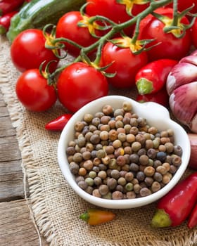 Raw organic roveja beans and vegetables on wooden table