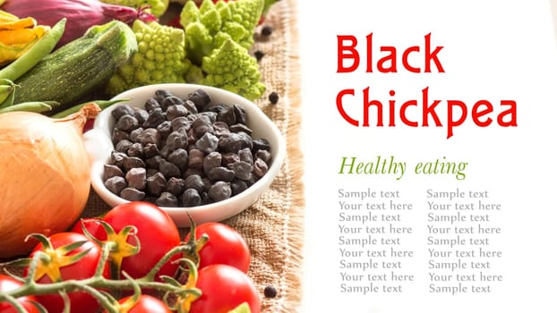 Black chickpea in a bowl with vegetables isolated on white
