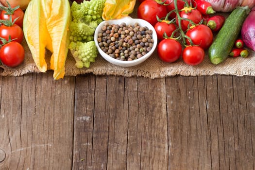 Raw organic roveja beans and vegetables on wooden table
