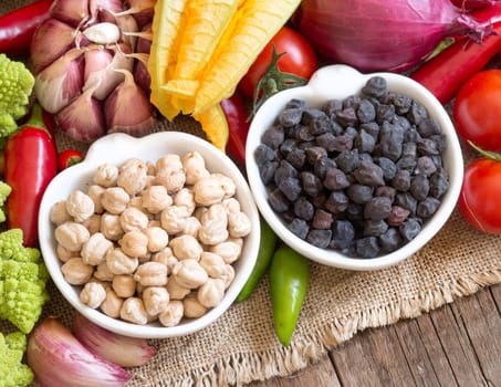 Black and white chickpea in bowls with vegetables