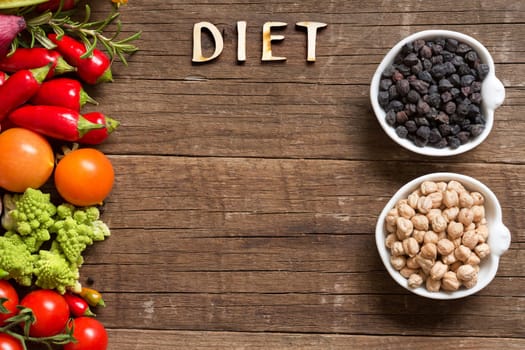 Vegetable, chickpea and word Diet on a wooden table background