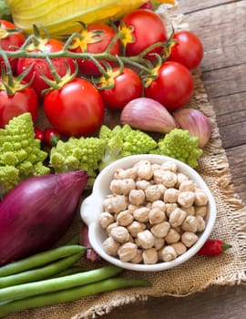 Dried organic chickpea in a bowl and vegetables