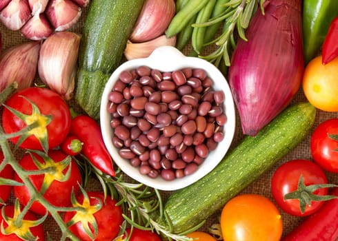 Dry organic azuki beans in a bowl and vegetables