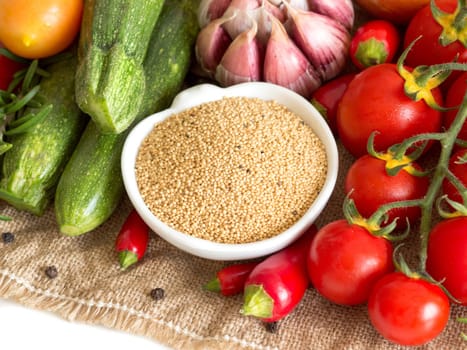 Raw organic amaranth in a bowl and vegetables