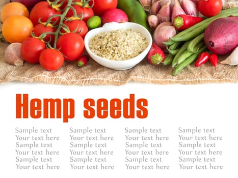 Raw organic hemp seeds in a bowl and vegetables
