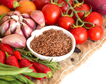 Red organic rice in bowl and vegetables