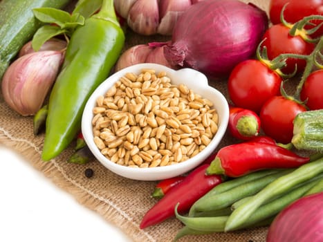 Whole wheat in a bowl and vegetables