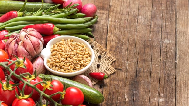 Whole wheat in a bowl and vegetables